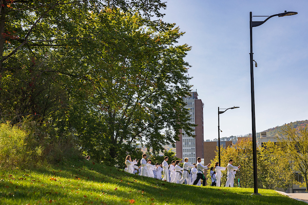 Students participate in a Taekwondo class outside.