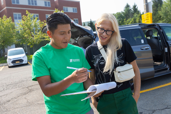 A member of move-in staff helping direct someone