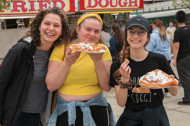Students at Spring Fling with fried dough.