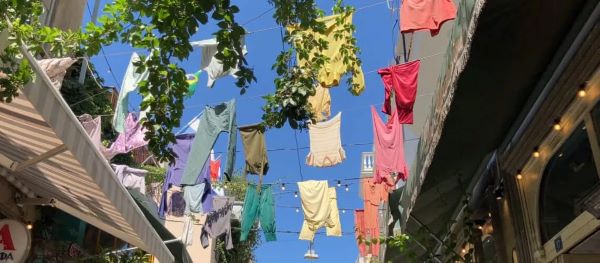 Clothes hanging on a clothesline between buildings in Athens, Greece.