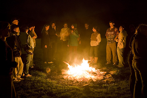 Students at a campfire on campus