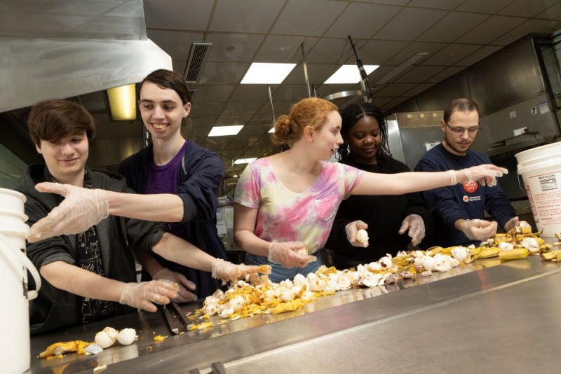 Students wear gloves and sort vegetables