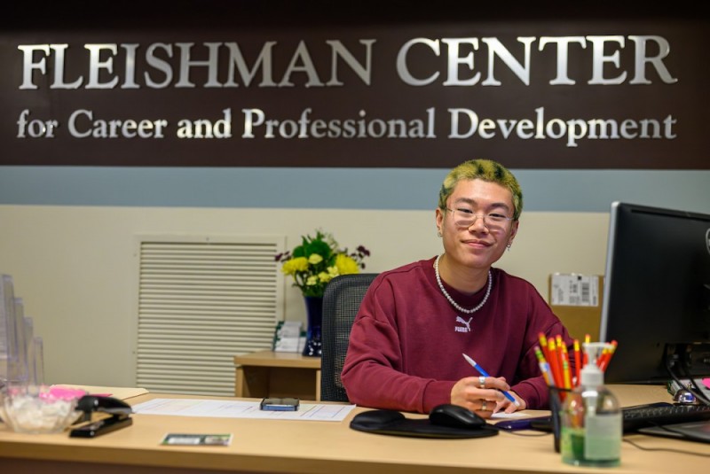 student worker at fleishman center desk