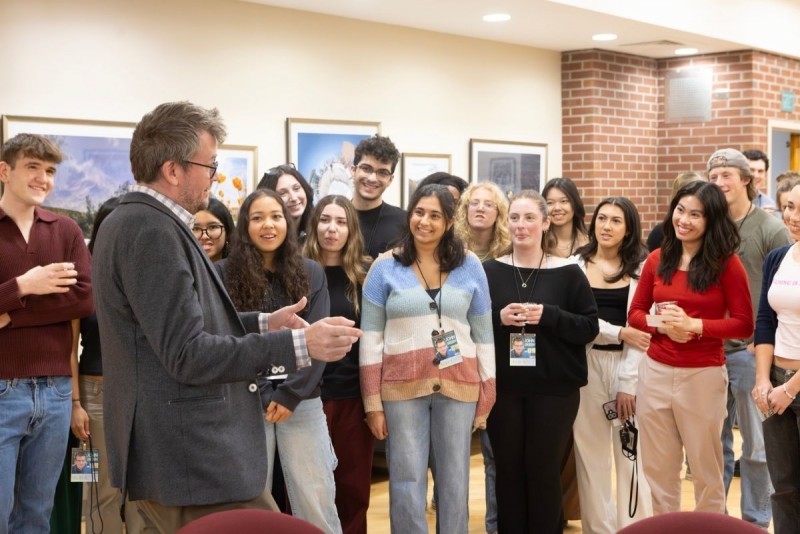 John Green speaks to a group of students in a room at the Anderson Center.