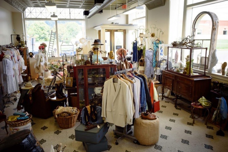 A small store with fashion clothing and antique items.
