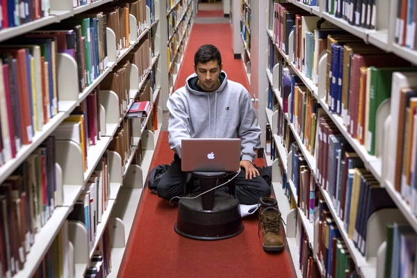 Students studying on the floor in the library