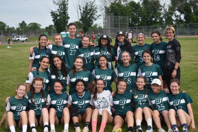 Members of ultimate frisbee club pose for a photo