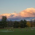 A beautiful sky is the backdrop of a 2017 intramural soccer game at the East Gym