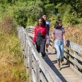 Three students hike in the Nature Preserve in 2019