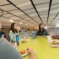 Friends smiling over a meal in Hinman Dining Hall