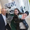 President Harvey Stenger takes a selfie with Baxter and a student.