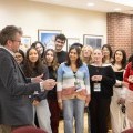 John Green speaks to a group of students in a room at the Anderson Center.