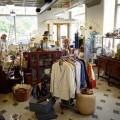 A small store with fashion clothing and antique items.