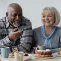Photo of seniors sitting at a table smiling