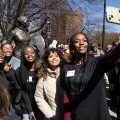 Several students take a selfie with a statue of Harriet Tubman.