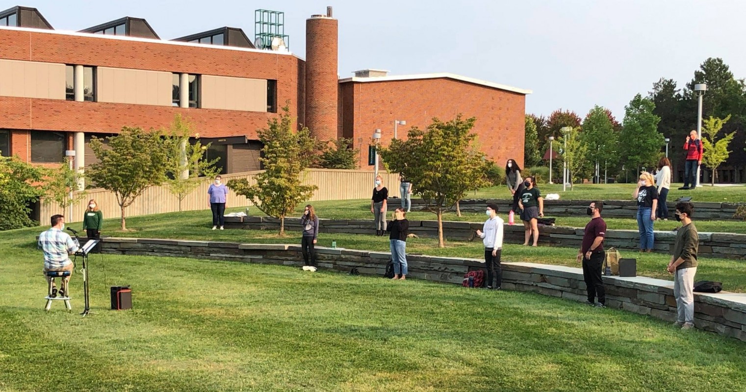Director of Choral Activities William Culverhouse leads the Harpur Chorale in an outdoors practice.