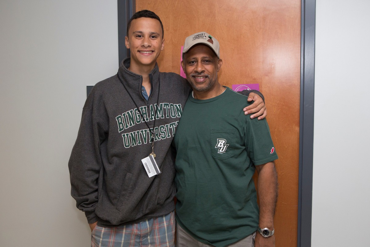 Trey Santiago-Hudson '18 and his father, actor, playwright and director Ruben Santiago-Hudson '78, during Move-In Day in August 2014.