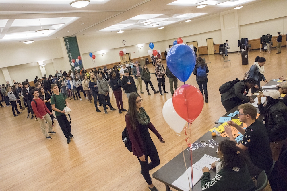 Students who live on campus wait in line in the Mandela Room on Tuesday, Nov. 8, 2016 to vote in the general election.