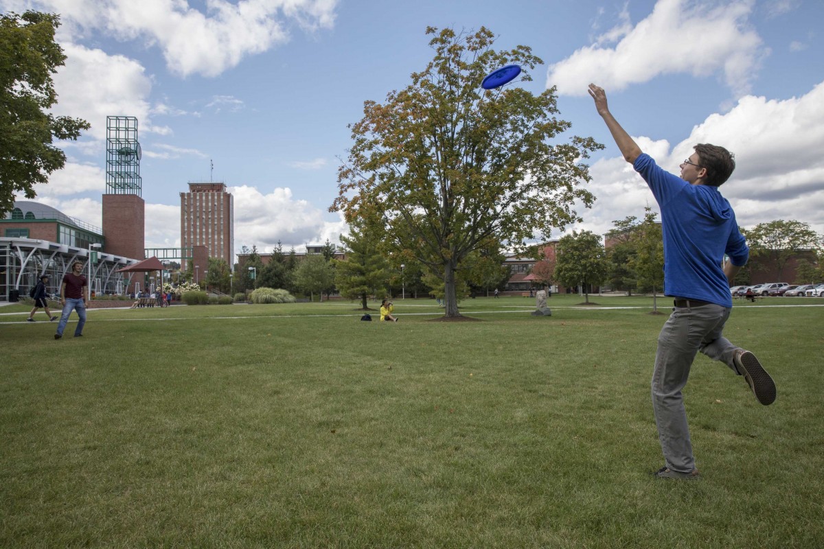 Students play Frisbee on the Peace Quad in 2017.
