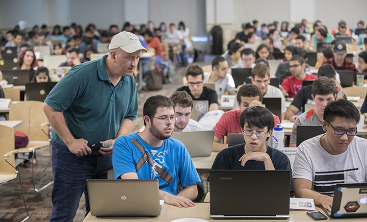 Jim Bankoski '90 (left) assisting students at the first-ever Binghamton University Google Games in fall 2017.