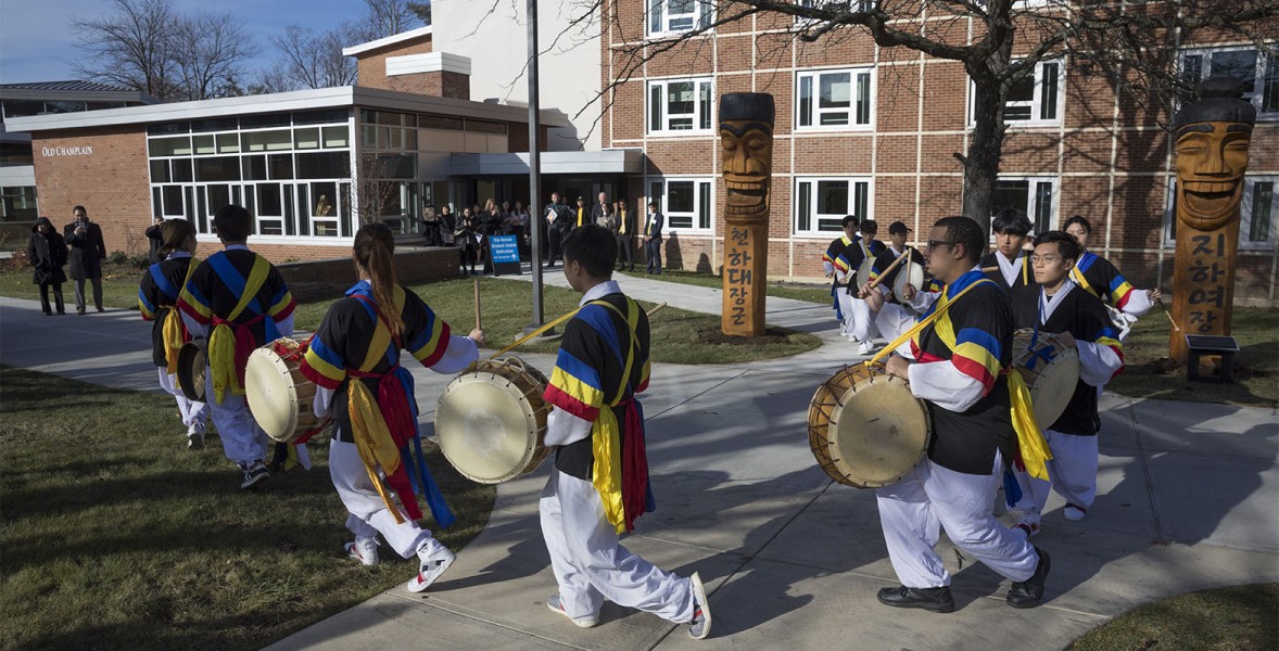 Members of Sul Poong, a student organization that performs Korean traditional percussion, entertains outside of Old Champlain to kick off the dedication of the Young Sam Kim Korean Student Center.