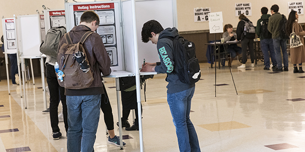 Binghamton University students cast their ballots at a voting poll located at Old Union Hall in the University Union on Tuesday, Nov. 6, 2018.