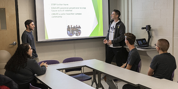From left: Gina Parisi, Bailey Germann, Brett Dowler, Colin Coughlan and Zachary Wilson, of the 20:1 bystander intervention programs, train at a University Union conference room.