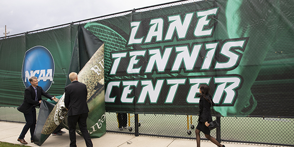 Michael F. Lane ’89, President Harvey Stenger and Lisa Marie Lane ’89, MA ’92 reveal the Lane Tennis Center signage at the dedication of the complex April 26, 2019.