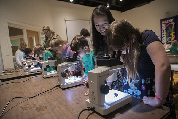 Jessica Hua, assistant professor of biological sciences at Binghamton University, with young students at Roberson Museum and Science Center in Binghamton.