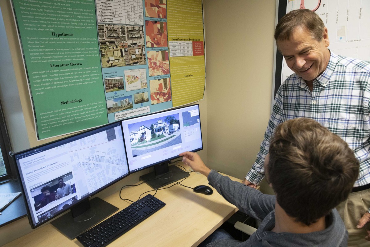 SUNY Distinguished Service Professor of Geography John Frazier works with a student involved in the Johnson City Research Project on Sept. 26, 2019.