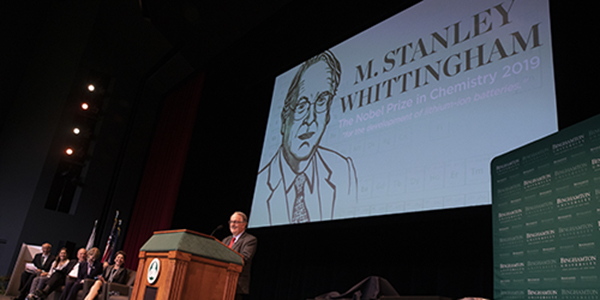 Distinguished Professor and Nobel Laureate M. Stanley Whittingham at the podium on the Osterhout Concert Theater stage.