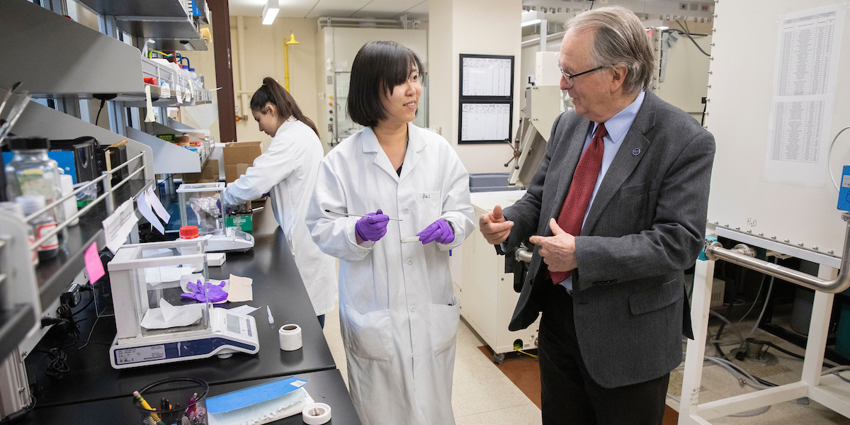 Nobel Laureate M. Stanley Whittingham, distinguished professor of chemistry and materials science, pictured here with his graduate students Ben Pei and Isiksu Buyuker, at the NorthEast Center for Chemical Energy Storage lab at the Center for Excellence at the Innovative Technologies Complex.