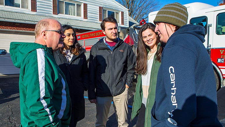 Vestal Fire Department Captain Chuck Paffie with (left to right) mechanical engineering students Katherine Frey, Brian Walsh, Audrey Nieuwenhuizen and Mikayla Morgan. Not pictured: Maurice Grossman.