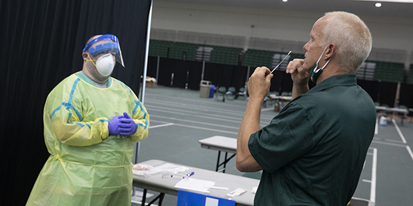 COVID-19 surveillance testing is ongoing in Old Union Hall. Here, President Harvey Stenger is tested prior to the beginning of the semester, with assistance from pharmacy student Allen Terry.