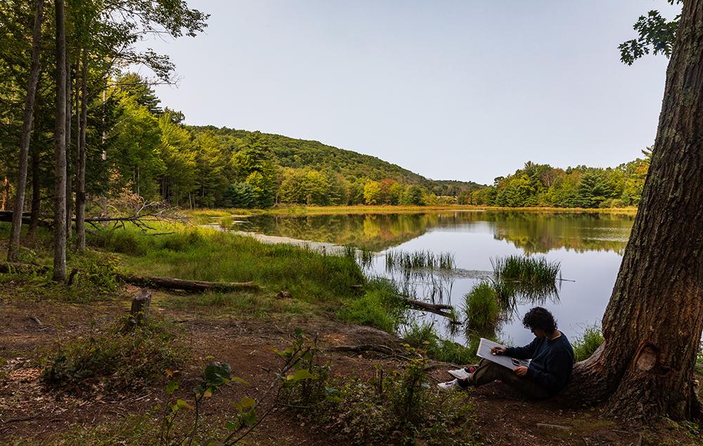Santiago Parra found a solitary spot along the water’s edge during a drawing class held in the Nature Preserve.