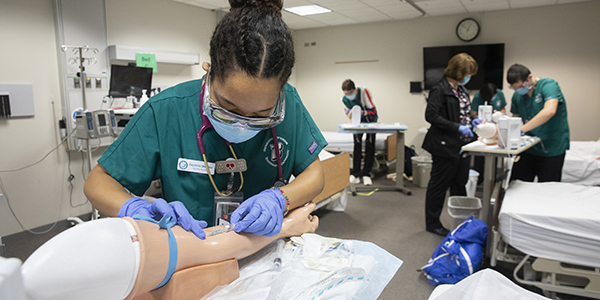 Decker College of Nursing and Health Sciences students participate in a clinical experience at the Innovative Simulation and Practice Center taught by Alison Dura on Oct. 22, the first day of class after the University went on a two-week pause during the COVID-19 pandemic.