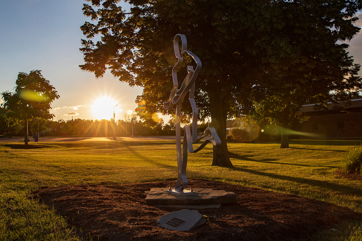 Sculpture of a running man that is in memory for alumnus Gregg David Wenzel '91, outside the West Gym.