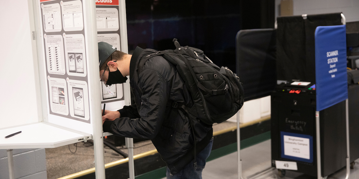 Daniel Coladangelo casts his vote in the 2021 election at the Binghamton University polling station located in the University Union's Undergrounds.