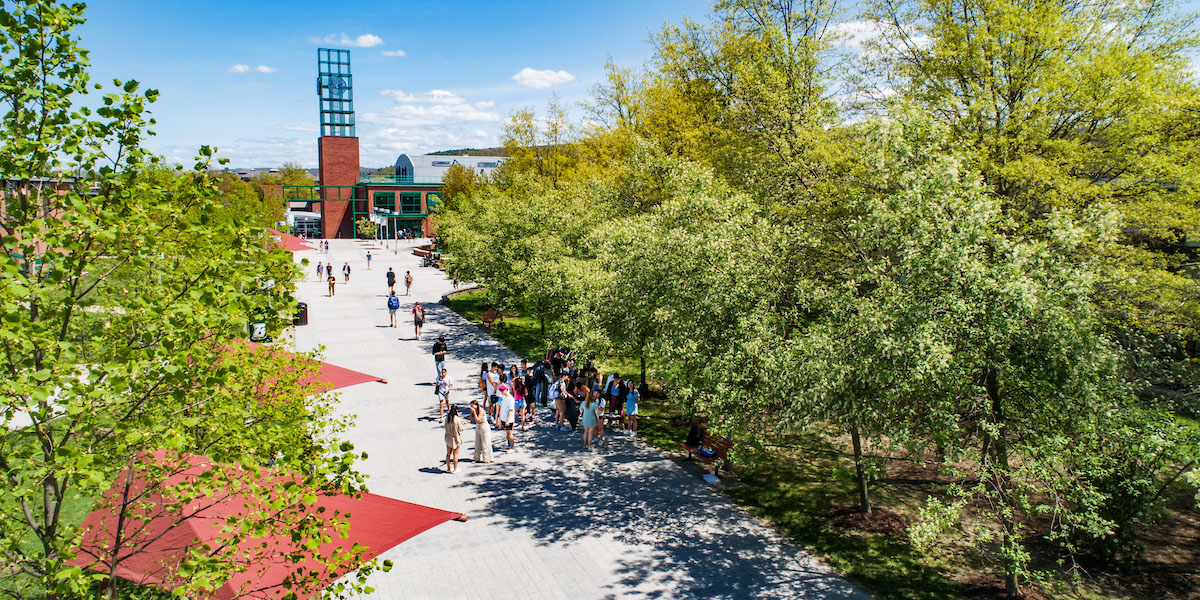 Students walk on the Lois B. DeFleur Walkway with The Union in the background.