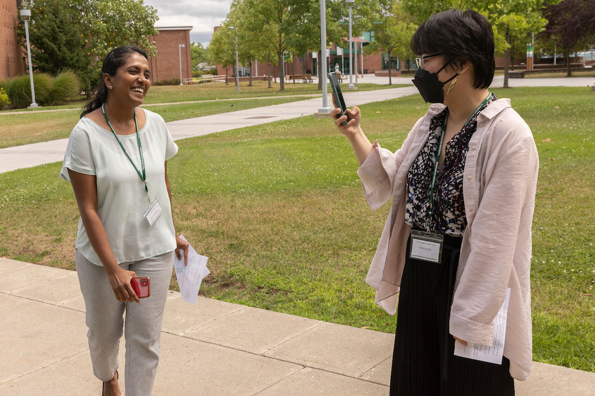 Nisha Varghese (left), lecturer of chemistry and graduate student of history Chuning Xie record each other for a video they will later produce on Au. 9, 2022.