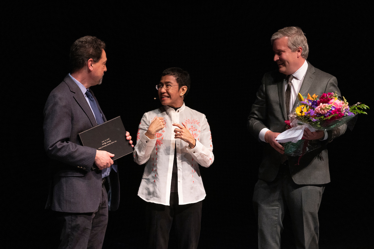 Nobel Peace Prize winner Maria Ressa accepts the inaugural Nadia Rubaii Memorial Prize from Max Pensky, left, and Kerry Whigham, co-directors of Binghamton University's Institute for Genocide and Mass Atrocity Prevention, on April 14, 2023.