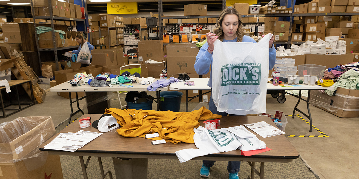 Izabella Bostina '23, left, and Nicole Dates '23 pack orders at Locker Room 345, a Binghamton-area charity that distributes clothing donated by Dick's Sporting Goods to low-income students.