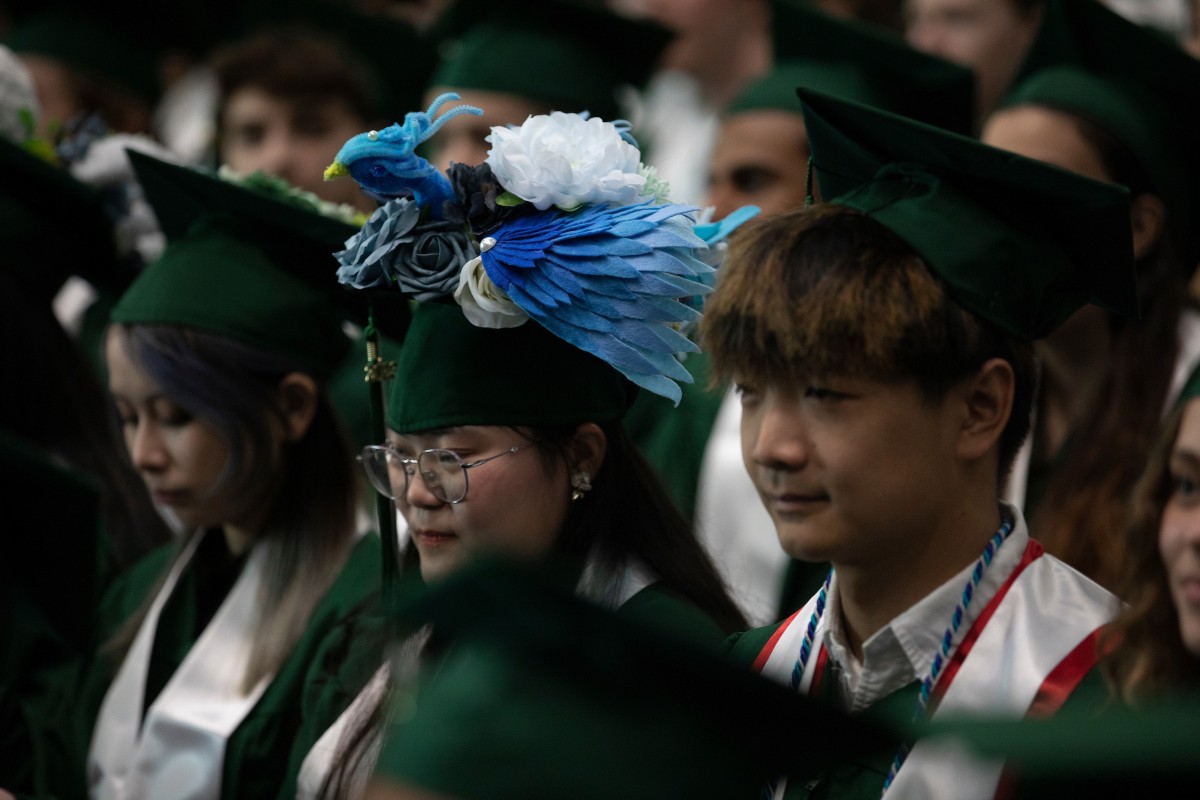 A student with an elaborately decorated mortarboard at the second Harpur Commencement ceremony on May 13, 2023.