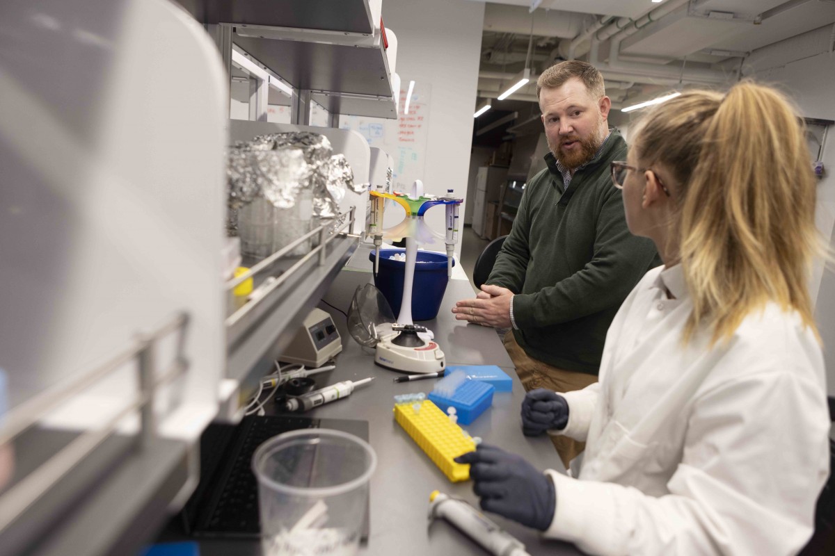 Associate Professor of Biological Sciences at Harpur College of Arts and Sciences Thomas Powell, photographed at his Science 4 laboratory, with his National Science Foundation Research Experience (NSFRE) undergraduate student and biology major and Lexie Greiber, June 16, 2023.