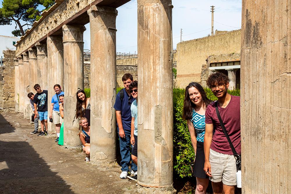 From left: Arthur O'Sullivan, Matthew Silber, Molly Goodwin, Grace Meyers, Chloe Vecchio, Abigail Rothleder, Aidan Walsh, James McCann and Antonio Ferrer participated in the Ancient Italy in Context course led by Associate Professor of Classical Studies Hilary Becker, second from right. This education abroad program was offered by Binghamton's Office of International Education and Global Initiatives (IEGI) and allowed students to visit archaeological and cultural sites in and around Rome and the Bay of Naples. Students are standing in a porticus of a Roman house at Herculaneum, a town that was destroyed by the eruption of Mt. Vesuvius in 79 A.D.