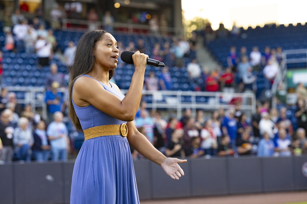 Ashanté Concepcion sings the national anthem at a Rumble Ponies game.