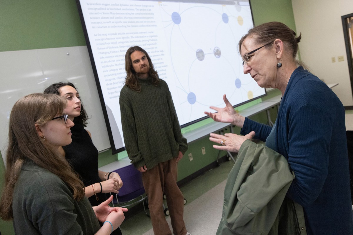 Associate Professor of History Wendy Wall speaks with students during a Research Days poster session on April 19, 2024.