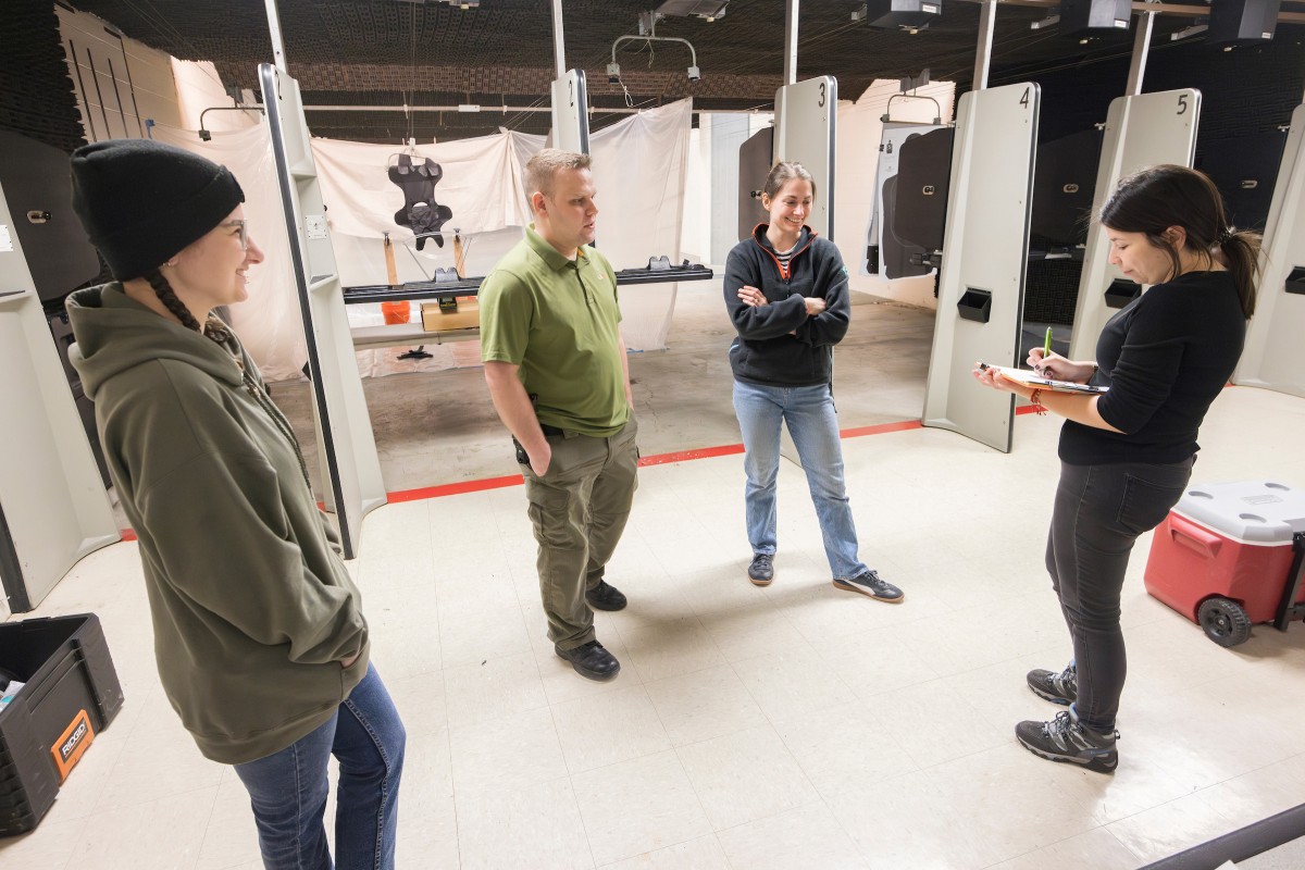 A ballistics experiment was held at the shooting range at the Tioga County Sheriff Office in Owego, NY, Thursday, March 21, 2024, led by Laure Spake, Assistant Professor of Anthropology at Harpur College of Arts and Sciences. Graduate student Mia Cucci, Sgt. Tom Gallagher, Spake, and Ph.D. candidate Alexandra Semma Tamayo have a discussion before the experiment.