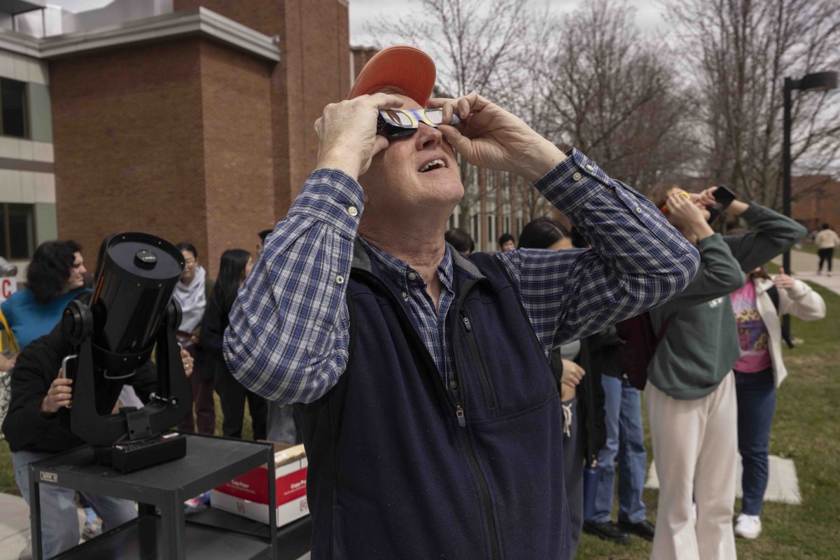 Mark Stephens, an instructional support specialist with the Physics Department, looks at the unfolding solar eclipse in the Science II courtyard.