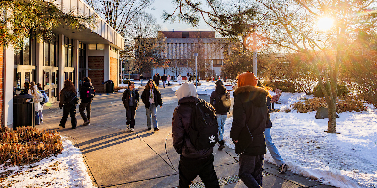 Crowds of students walk to class near the Lecture Hall.